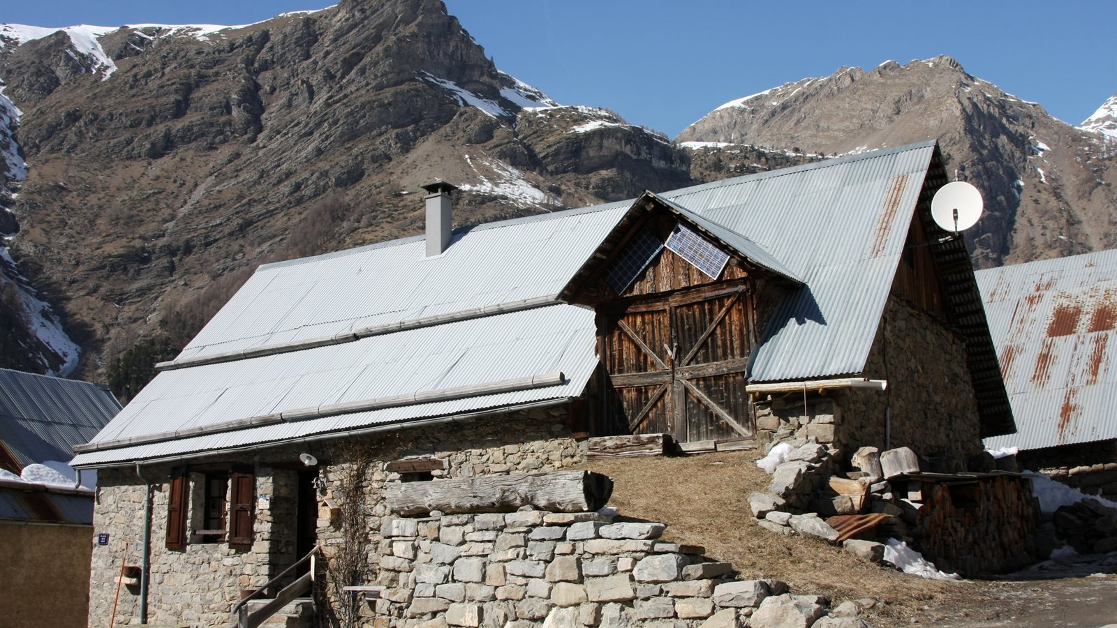 Traditional stone house with shuttered windows in a mountain village